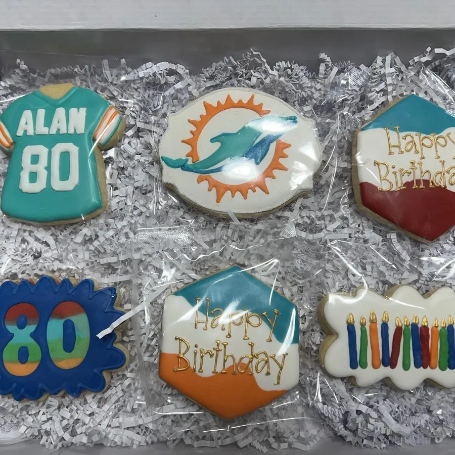 80th birthday cookies with a football jersey and birthday plaques