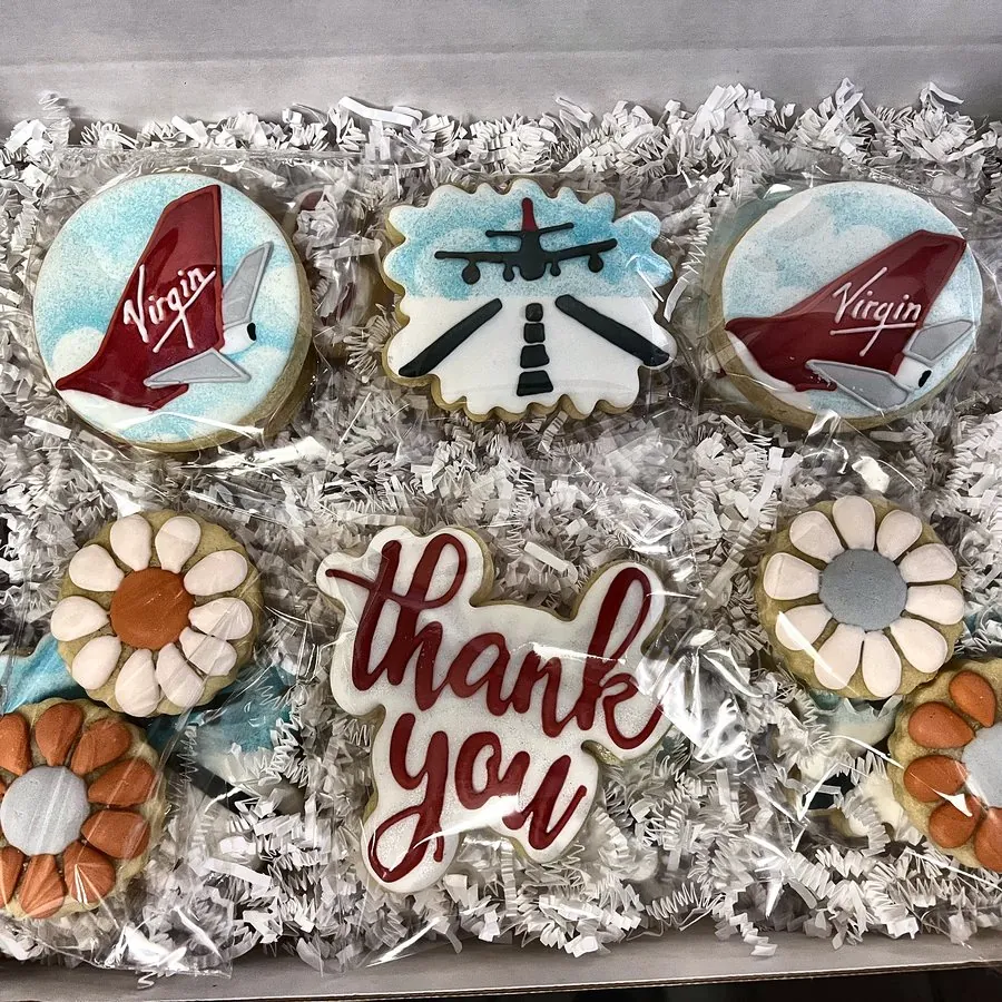 Printed airline tail-fin cookies with a piped thank-you plaque