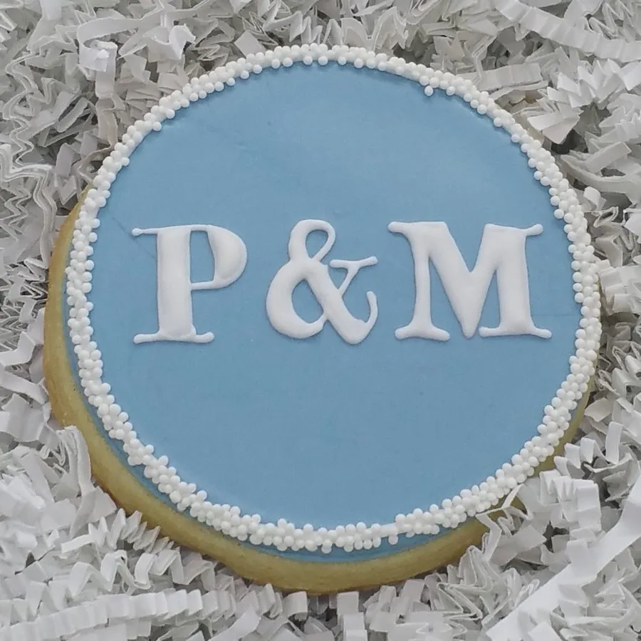 Round blue plaque with white P&M monogram